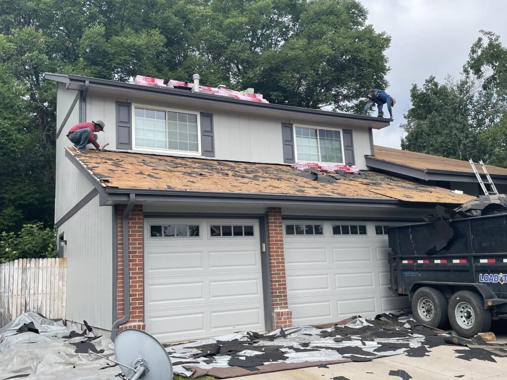 two men removing old roof